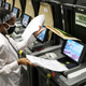 A Miami-Dade election worker feeds ballots into voting machines during an accuracy test at the Miami-Dade Election Department headquarters on October 14, 2020, in Doral, Florida.